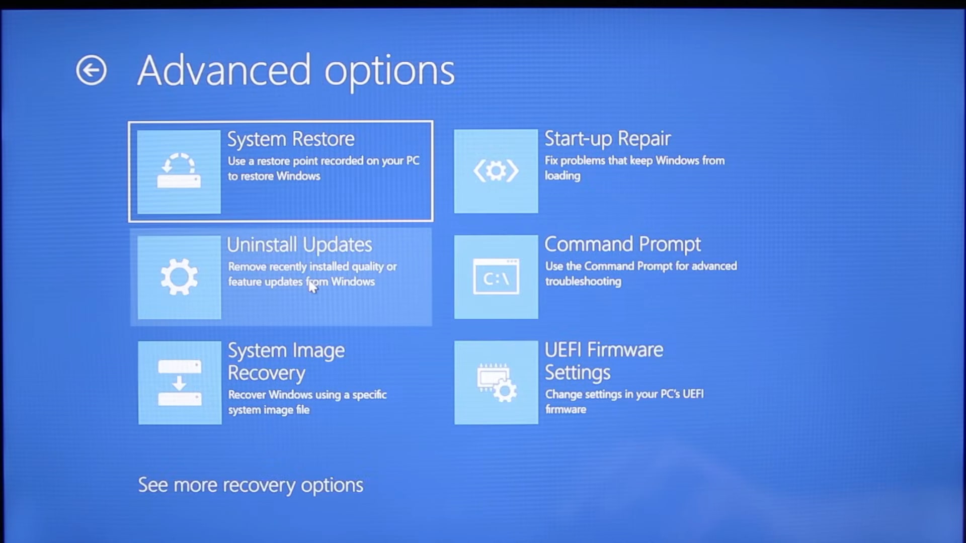 A computer screen displaying Windows Advanced Options, including System Restore, Uninstall Updates, Start-up Repair, Command Prompt, System Image Recovery, and UEFI Firmware Settings